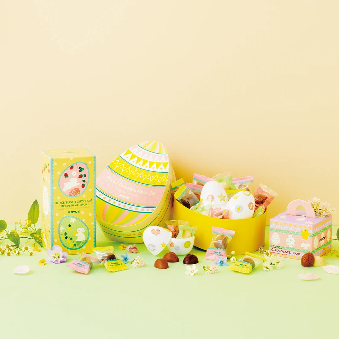 Easter chocolate display featuring a large egg-shaped gift box, Royce Bunny Chocolat box, tray with chocolates, and a Royce handle-box.