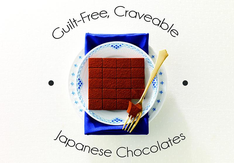 Square slab of Japanese chocolate on a blue-floral plate, dusted with cocoa. Gold fork lifts a piece. Text: Guilt-Free, Craveable Japanese Chocolates.