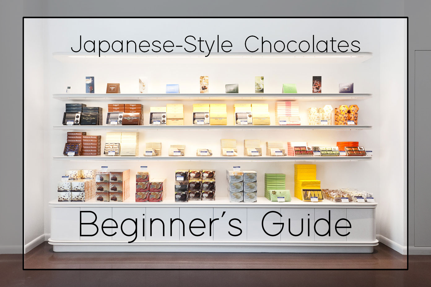 Display of assorted packaged chocolates on white shelves with overlaid text: Japanese-Style Chocolates and Beginner’s Guide, resembling a guide cover.
