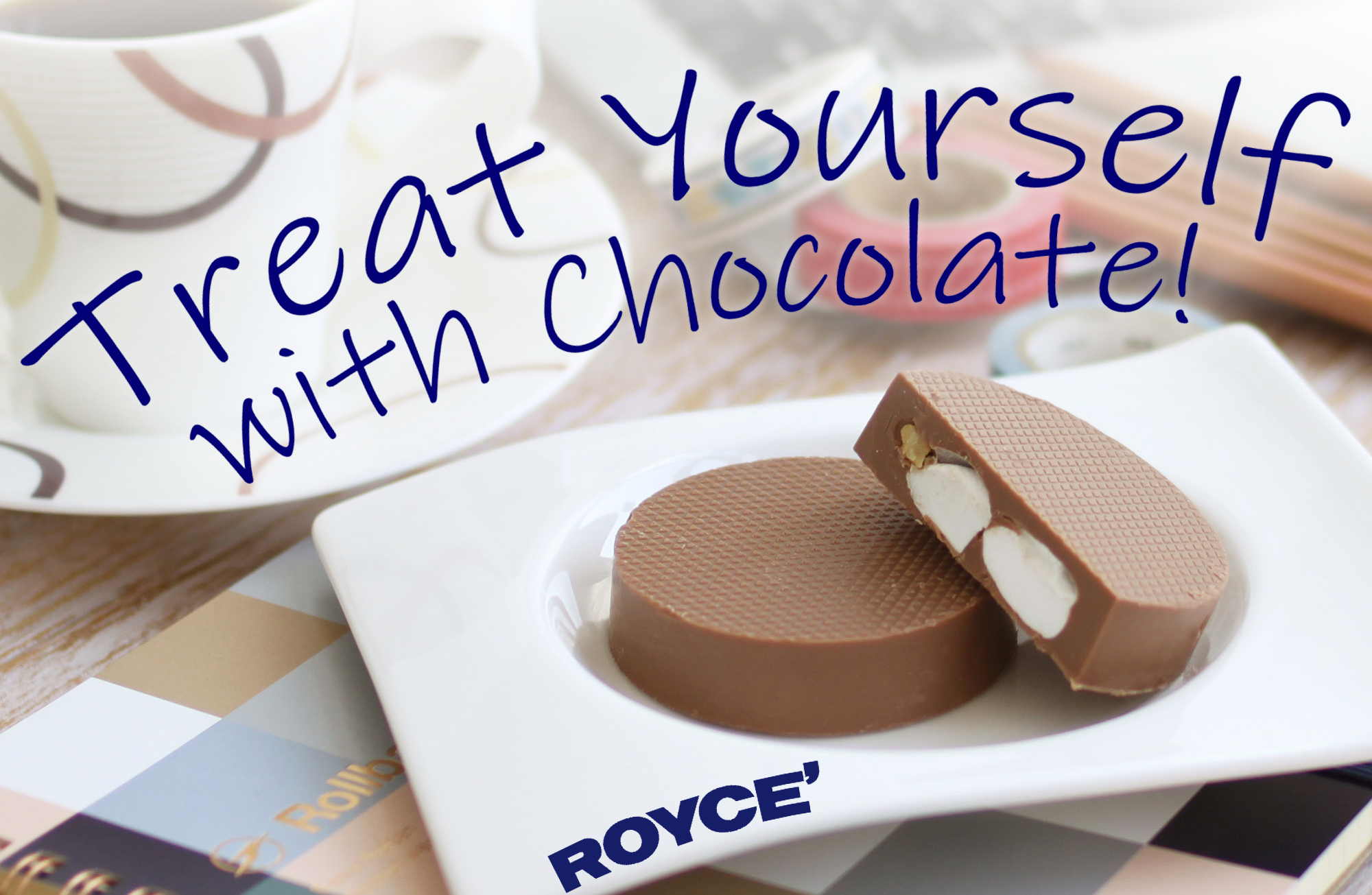 Top-down view of a chocolate promotion featuring milk-chocolate pucks with marshmallow and nuts, beside a patterned mug. Text: “Treat Yourself with Chocolate!” ROYCE’.