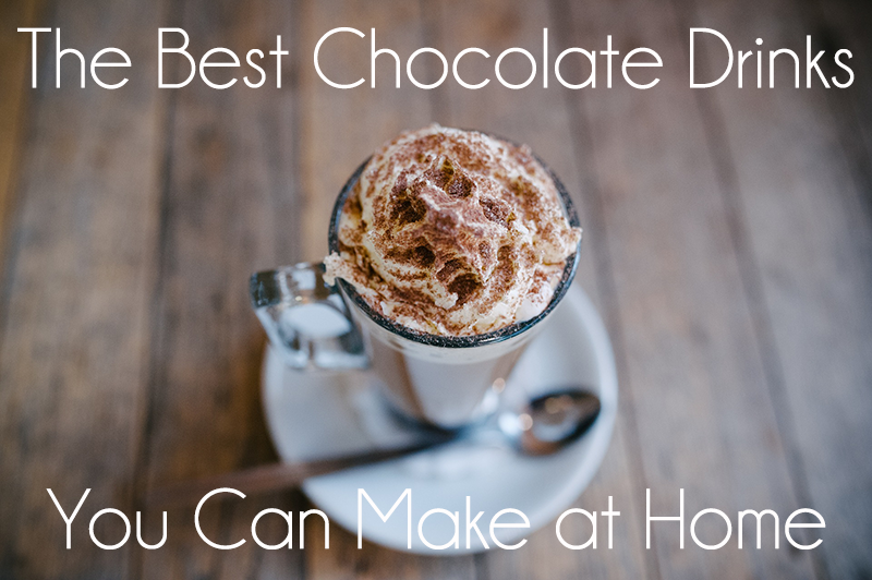Tall glass mug of hot chocolate with whipped cream and cocoa on a saucer. Overlay text: “The Best Chocolate Drinks You Can Make at Home”.