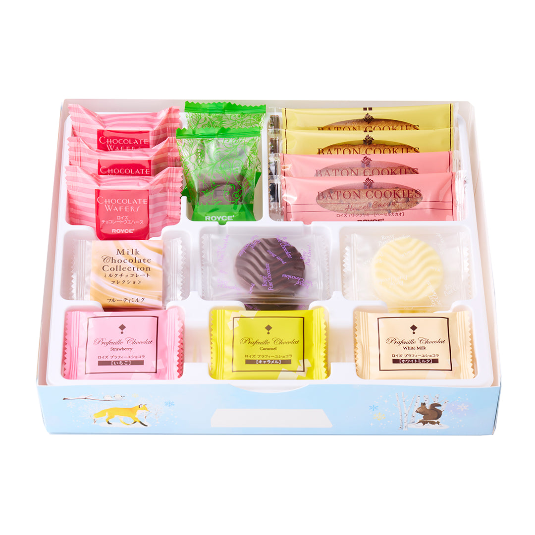 A boxed assortment of gourmet chocolates and cookies in a light blue tray with illustrations.
