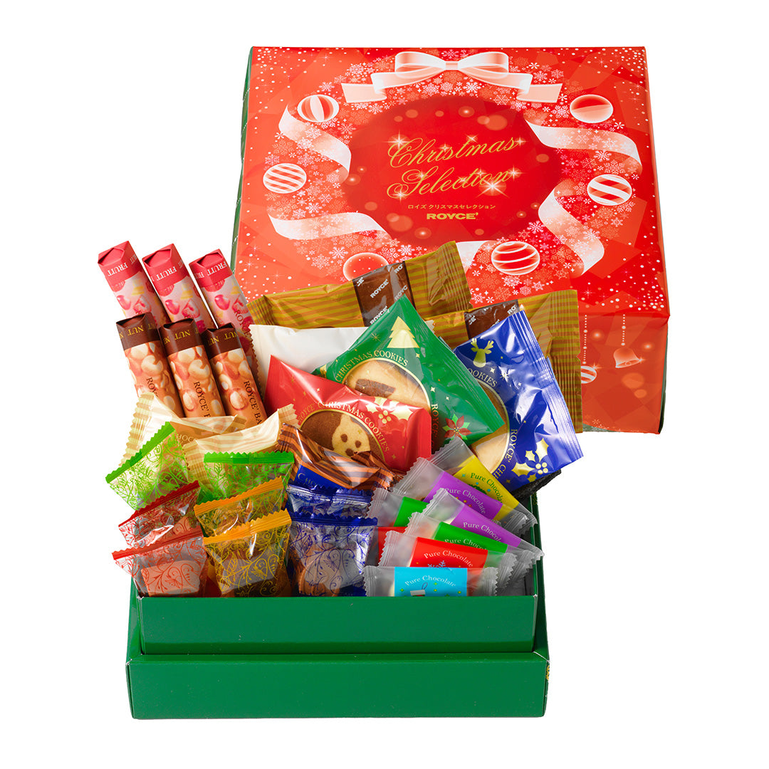 Image on lower left shows a green box with individually-wrapped chocolates. Image on upper right shows a red box with prints of snowflakes, balls, and ribbons. Text says Christmas Selection ROYCE'. Background is in white.