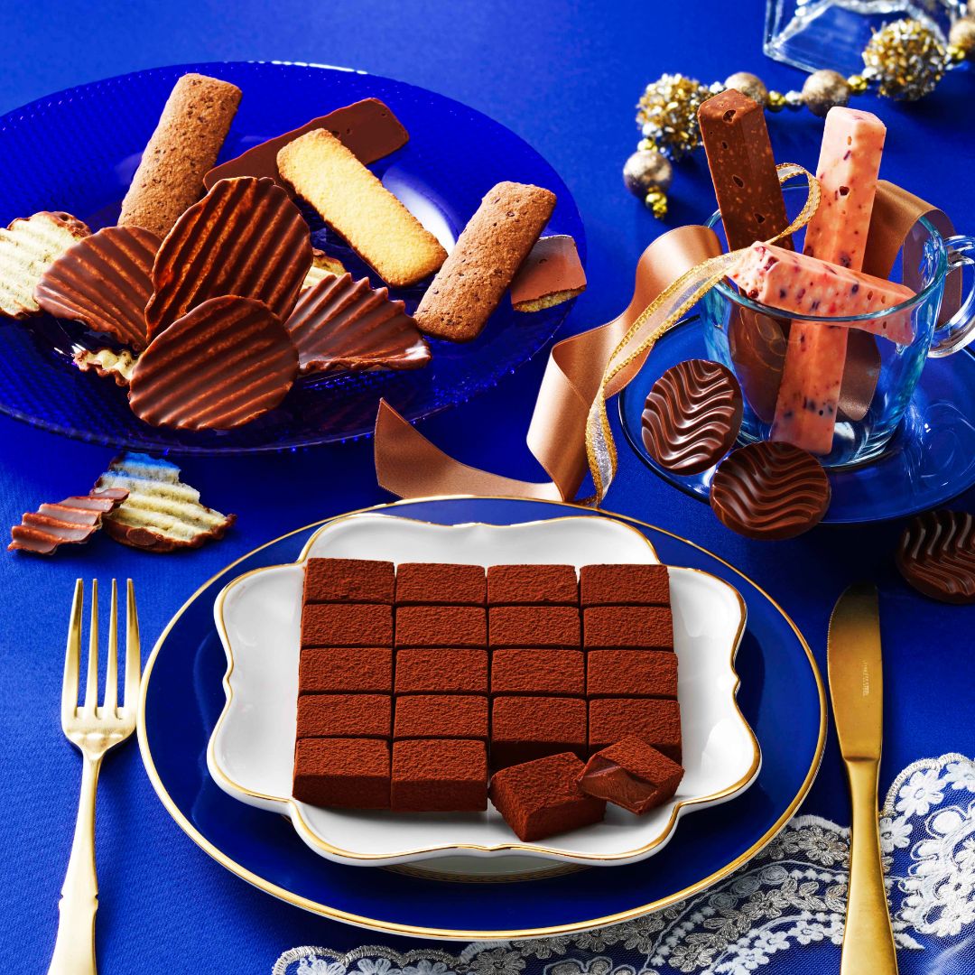 Image shows chocolates on plates with golden utensils.