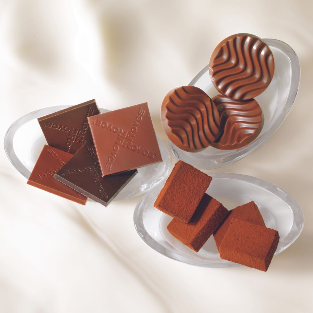 Image shows chocolates on clear bowls with a white background.