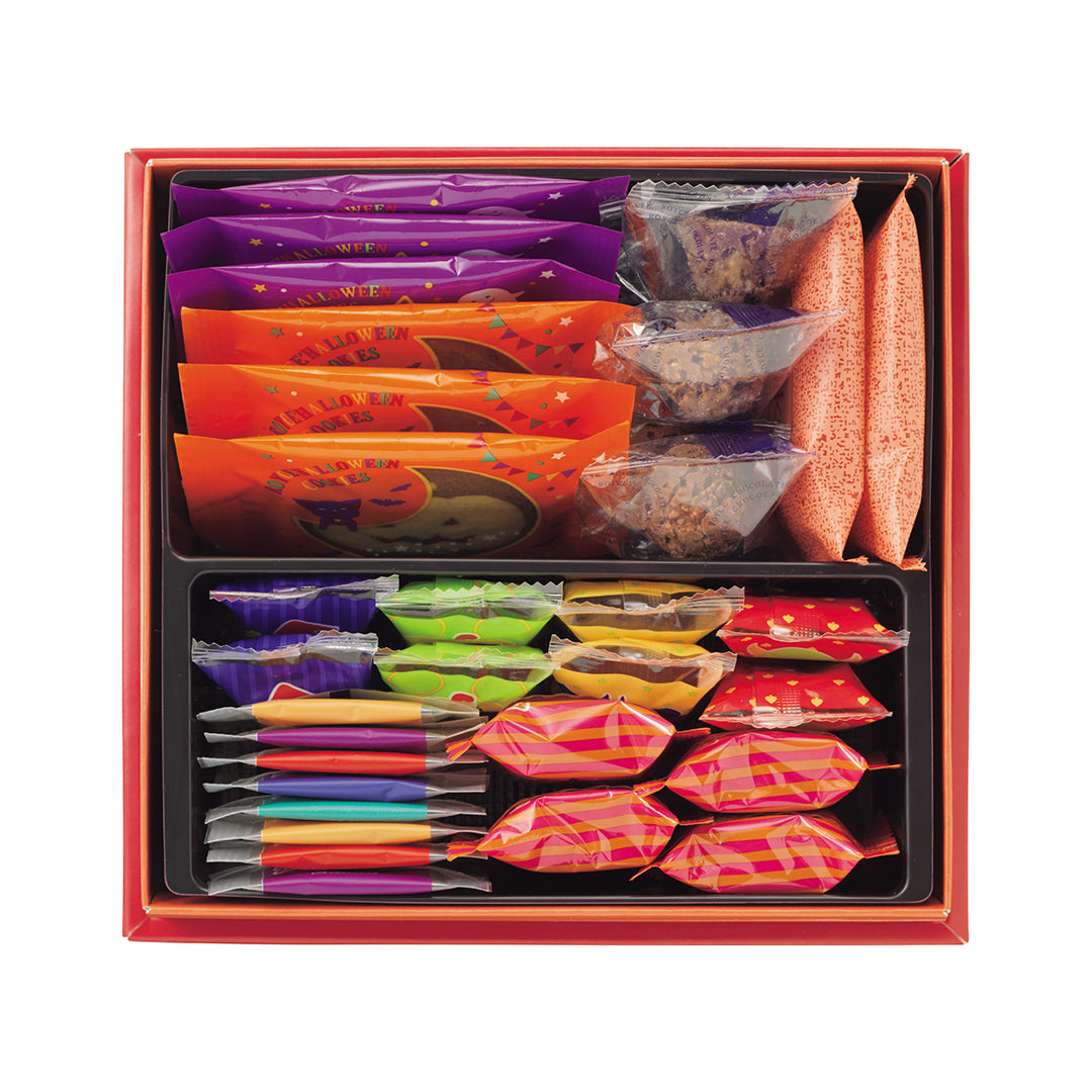 ROYCE' Halloween Happy Selection - A red gift box filled with assorted packaged snacks and cookies, arranged in compartments. The box contains colorful individually wrapped sweets, all photographed on a plain white background.