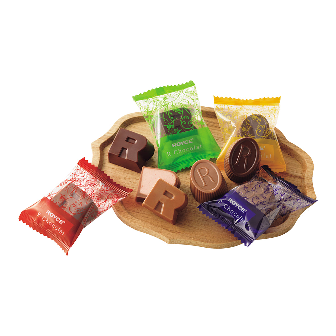 ROYCE' Halloween R Chocolat - Image shows chocolates and wrapped confections on a wooden plate. Background is in white.
