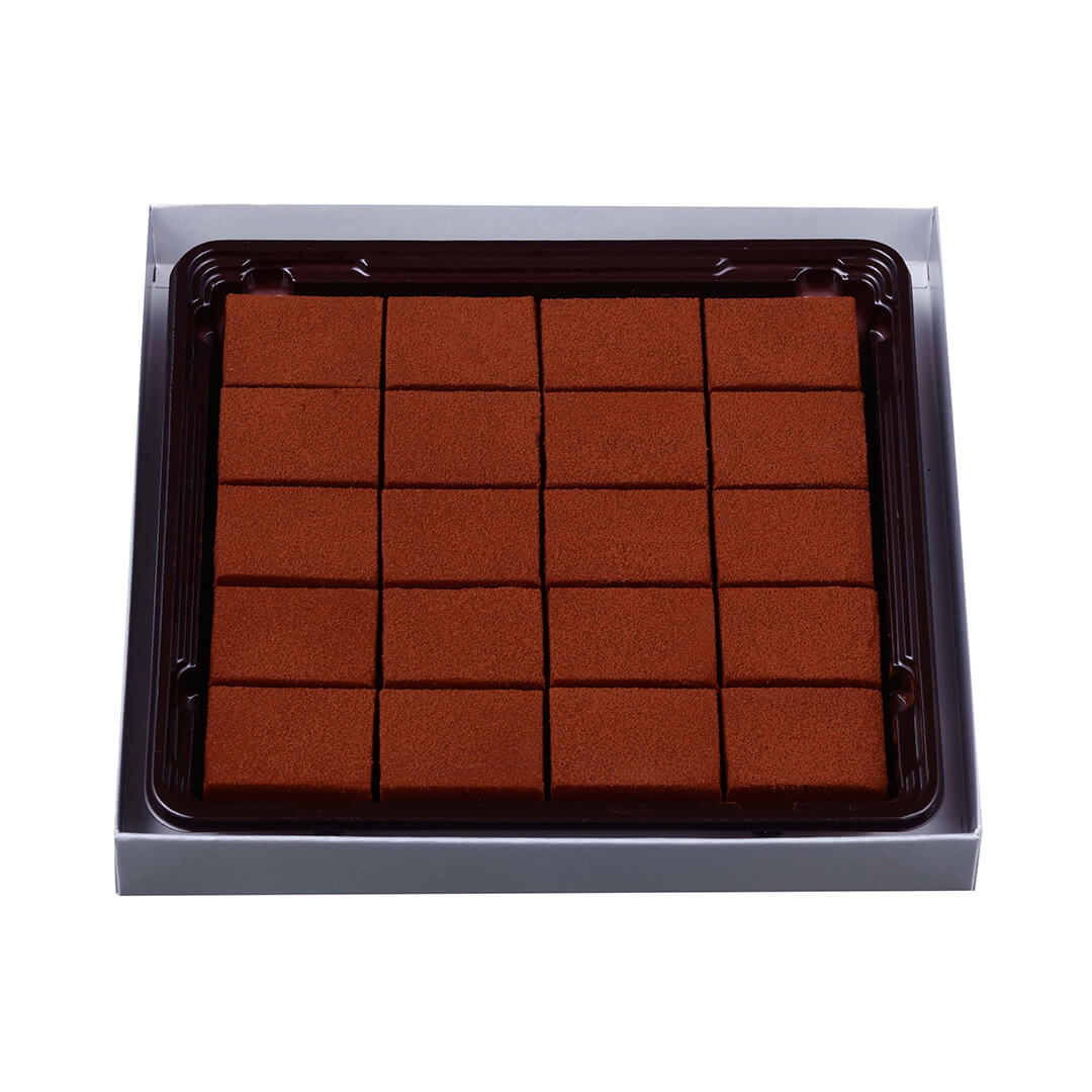 ROYCE' Chocolate - Nama Chocolate "Caramel Milk" - Image shows gray box with brown tray inside filled with brown chocolate blocks.
