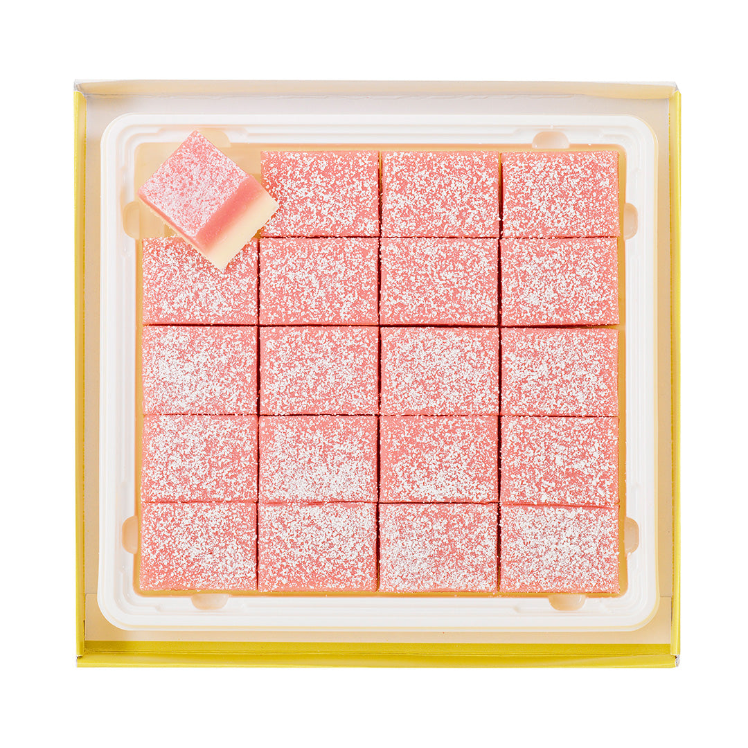 Image shows a box with pink chocolate blocks inside.