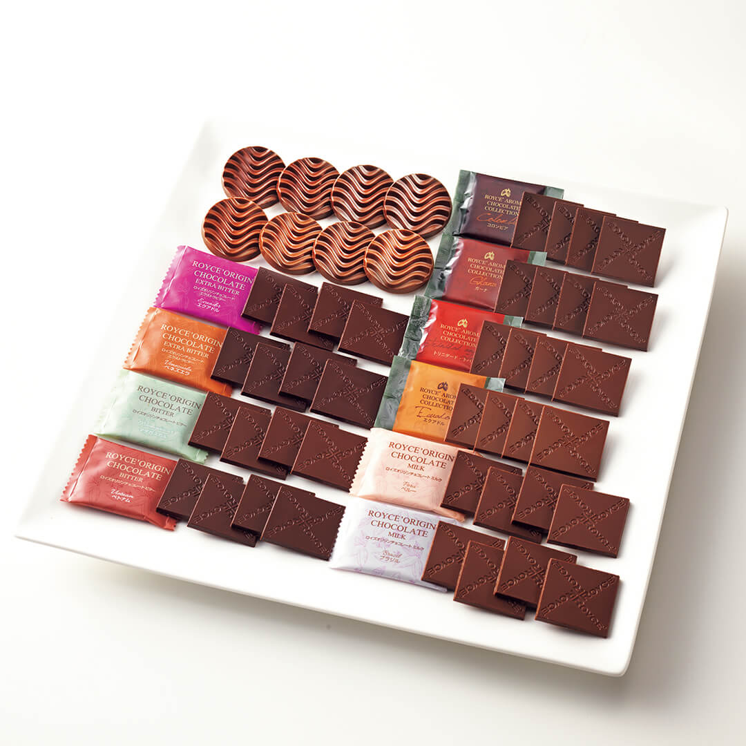 ROYCE' Chocolate - ROYCE' Tasting Box - Image shows different kinds of chocolates in various shapes, sizes, and colors. They are arranged on a white tray.