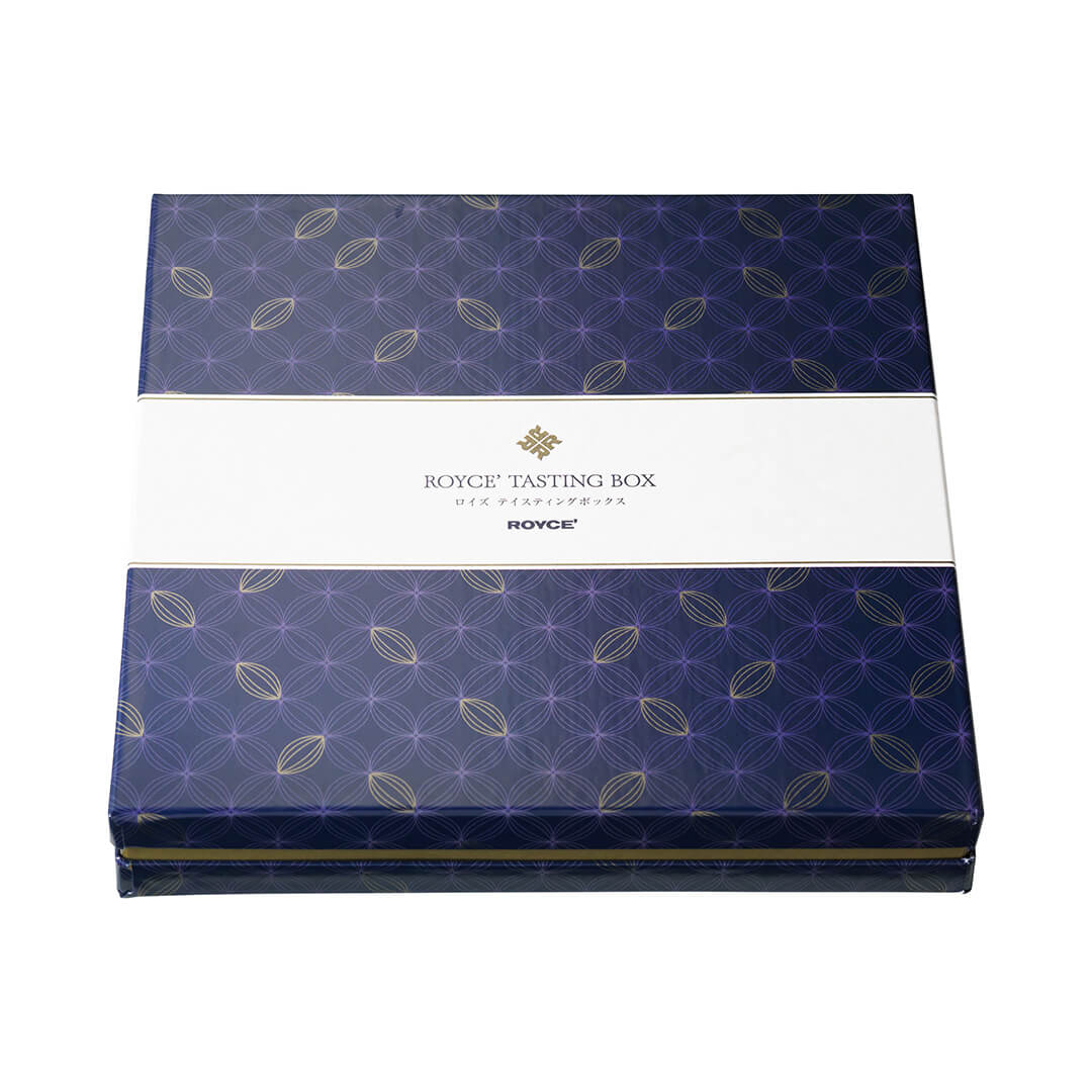 ROYCE' Chocolate - ROYCE' Tasting Box - Image shows a blue box with cacao prints and a white center. Text in center says ROYCE' Tasting Box ROYCE'.