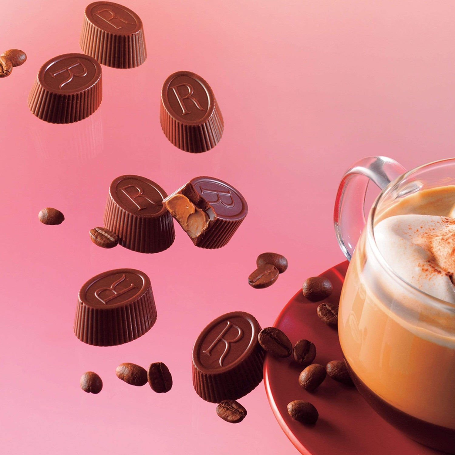 ROYCE' Chocolate - ROYCE' R Chocolat "Caffé Mocha" - Image shows oval-shaped brown chocolates engraved with the letter R. Accents include brown coffee beans and a cup of coffee on a plate. Background is in pink.