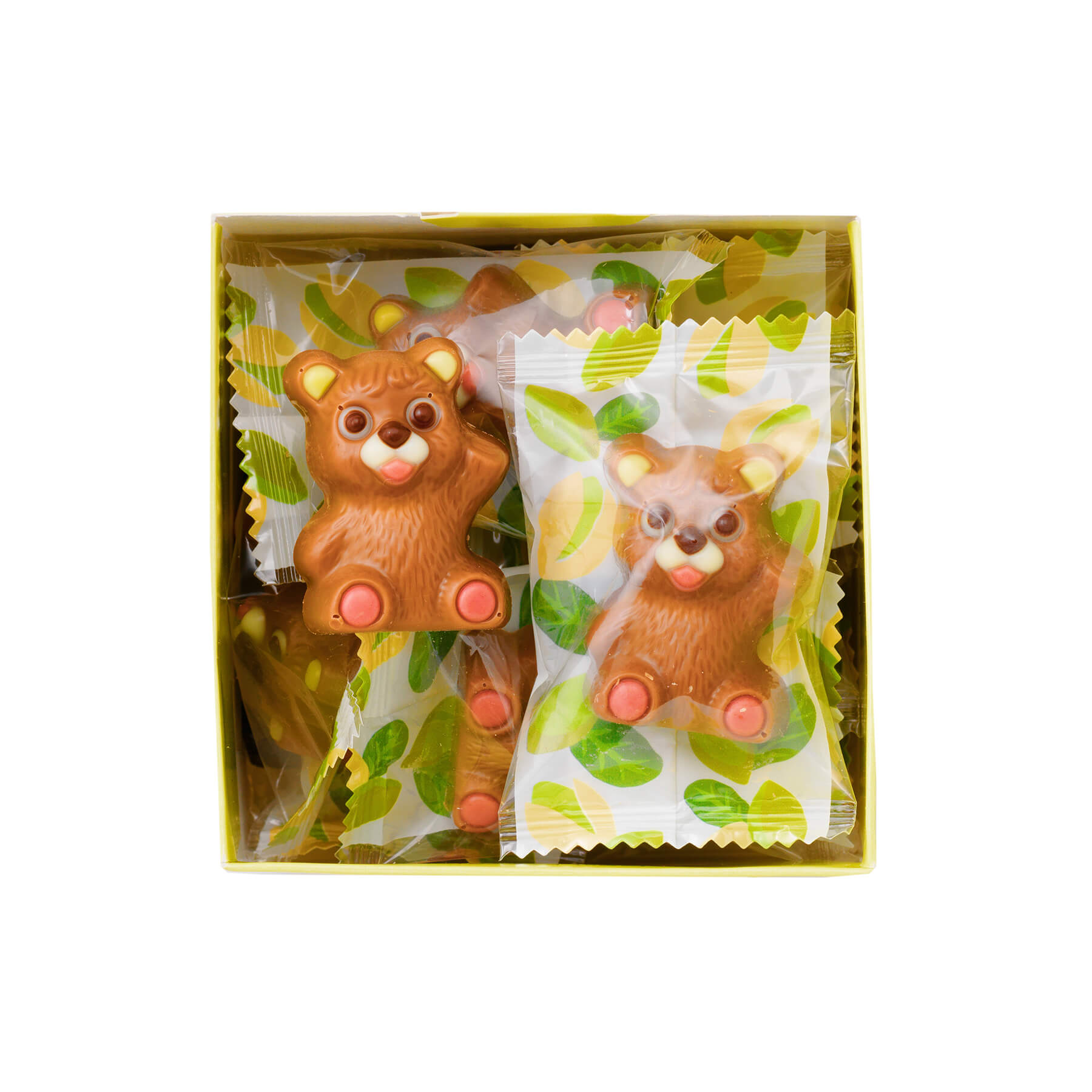 Petit Bear Chocolat Pistachio features milk-chocolate bears with pistachio cream, detailed in colored chocolate, wrapped in clear, leaf-motif wrappers.