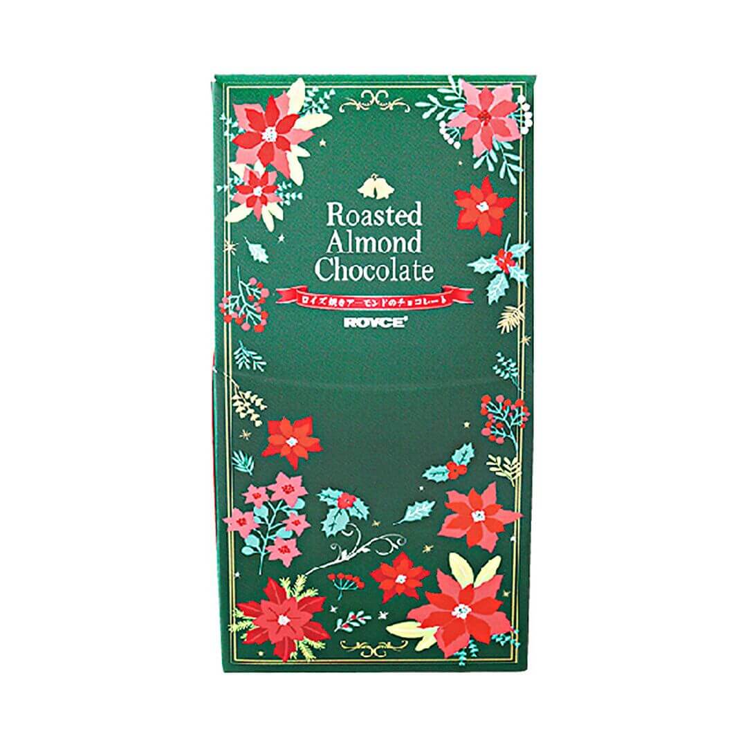 Image shows a pointed box in green and red with prints of leaves and flowers in the colors of green, yellow, red, pink, and white. White text in the middle says Roasted Almond Chocolate. ROYCE'.