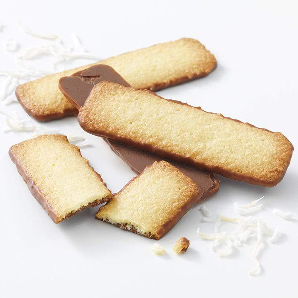 ROYCE' Chocolate - Baton Cookies "Coconut" - Image shows golden cookies with brown chocolate coating and white coconut shavings on a white-colored surface.
