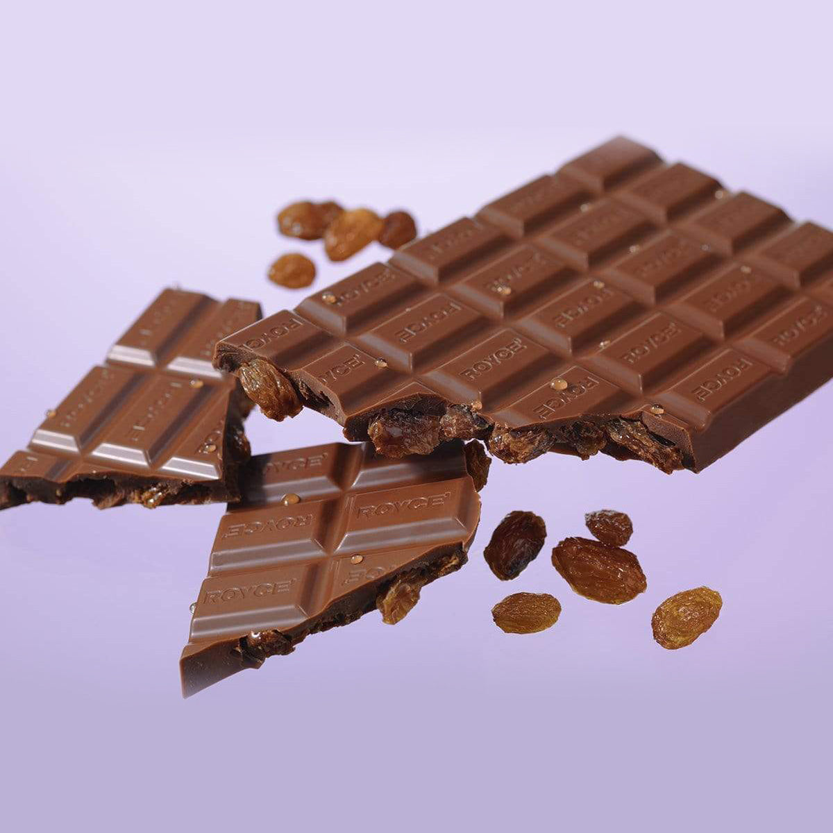 ROYCE' Chocolate - Chocolate Bar "Rum Raisin" - Image shows brown chocolate bars with raisin and the word "ROYCE'" engraved. Background is purple in color.