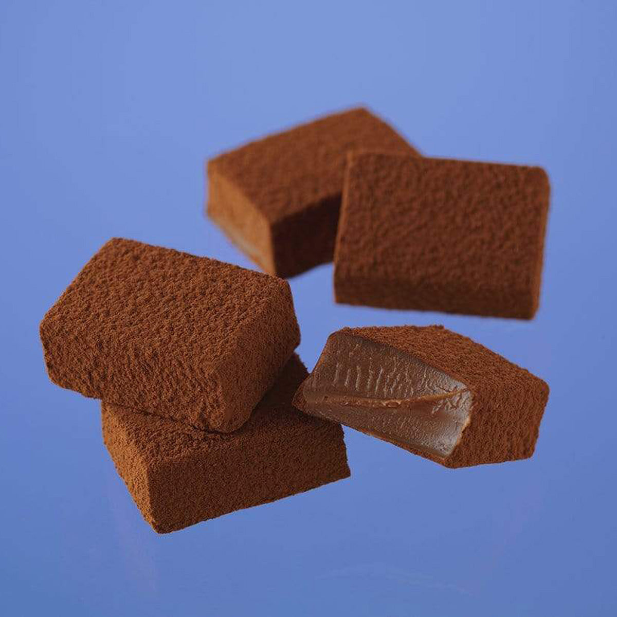ROYCE' Chocolate - Nama Chocolate "Au Lait" - Image shows brown blocks of chocolate with blue background.