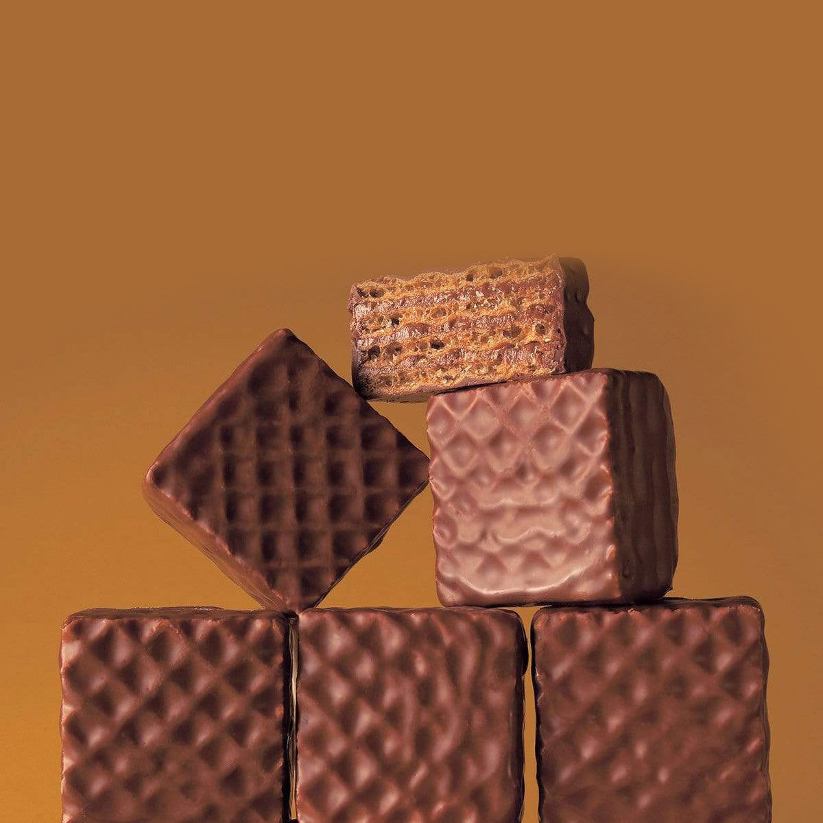 ROYCE' Chocolate - Chocolate Wafers "Hazel Cream" - Image shows stacks of brown chocolate wafers with a crisscrossed texture. Background is in brown. 