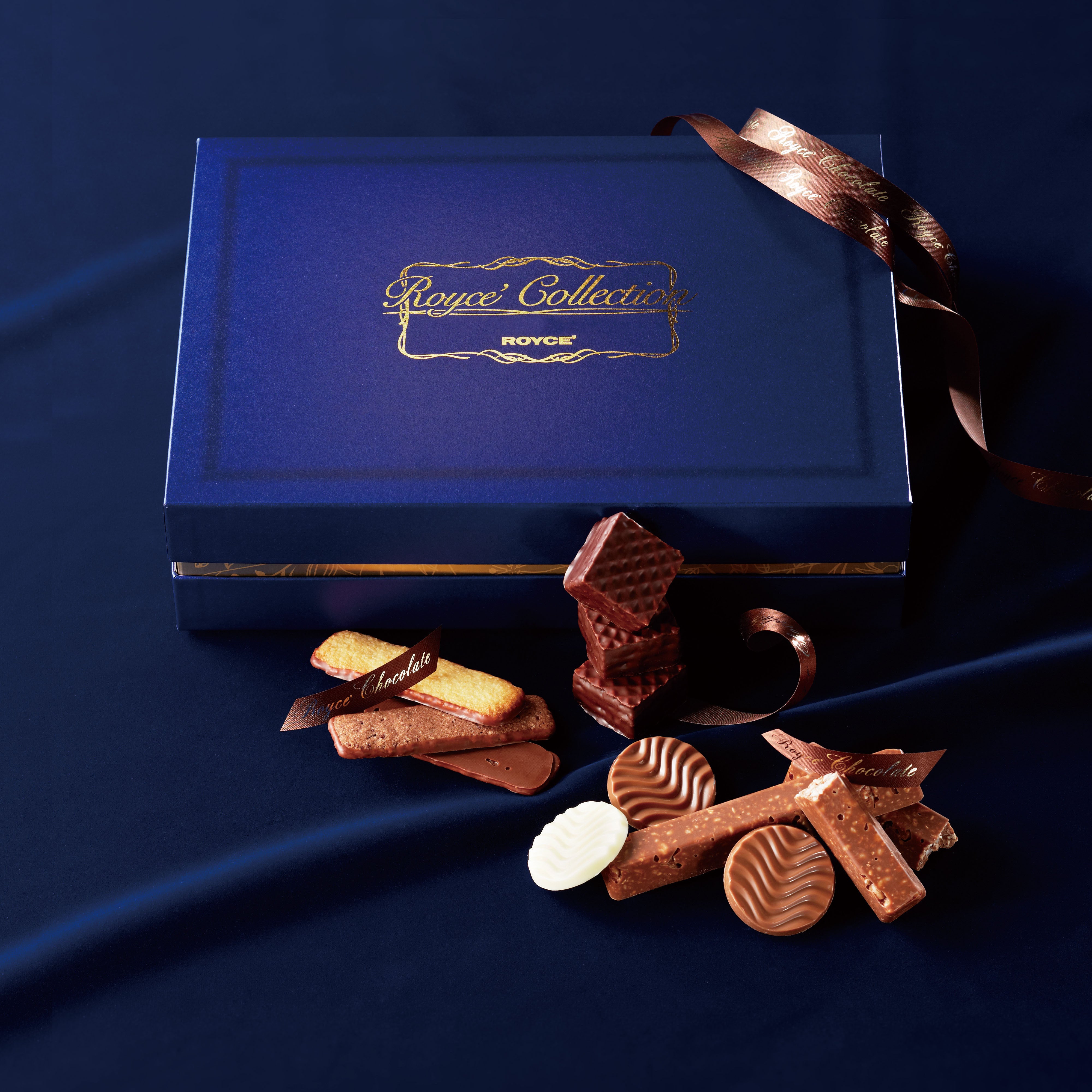Image shows a blue box of ROYCE' Collection "Blue" with some chocolates and ribbons.