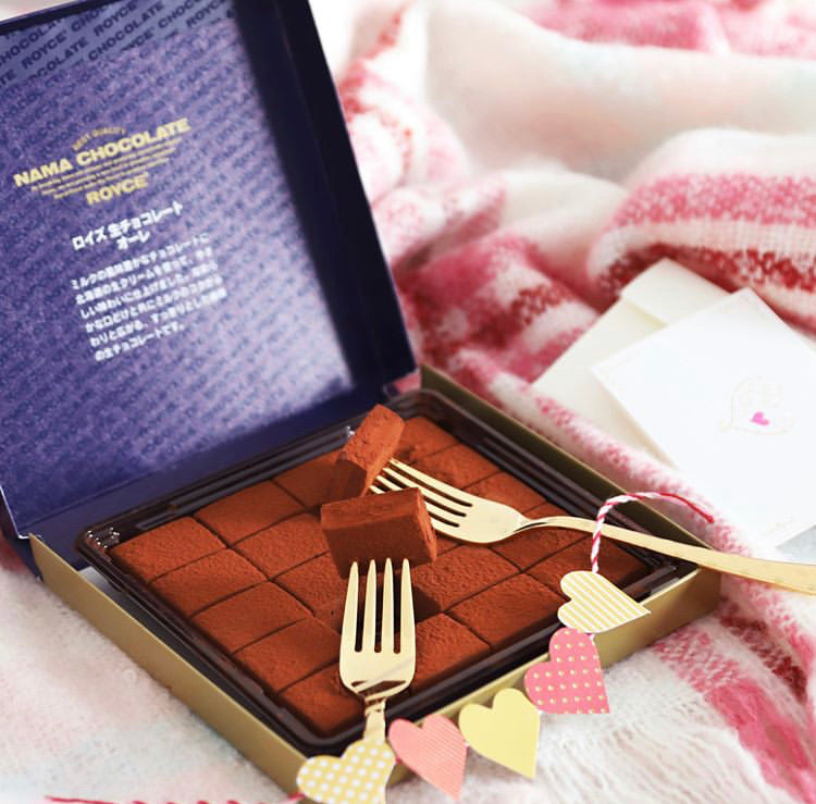 Image shows ROYCE' Nama Chocolate blocks in a box with hearts and golden forks.