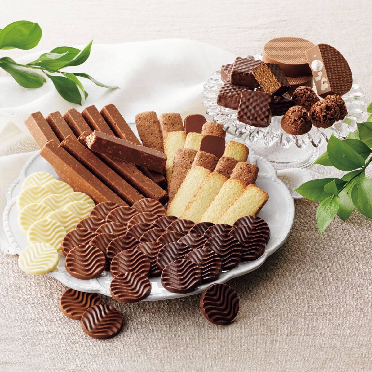 ROYCE’ Collection Blue platter with assorted chocolates and cookies: truffles, wafers, butter cookies, nut-studded bars, and medallions, elegantly arranged for a luxurious treat.