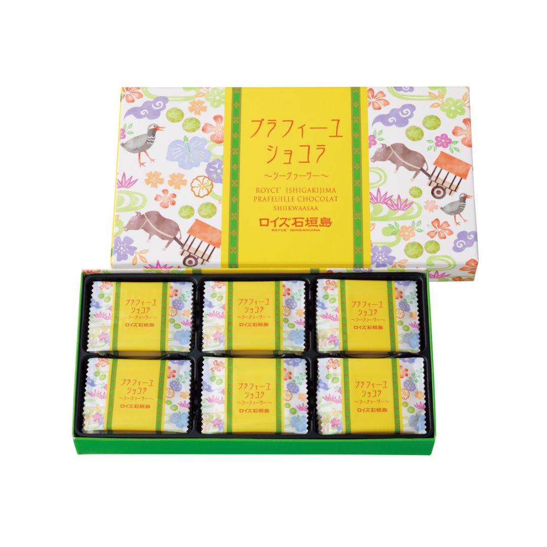 Image shows a printed box with illustrations of animals and plants. Text says ROYCE' Ishigakijima Prafeuille Chocolat Shiikwaasaa.