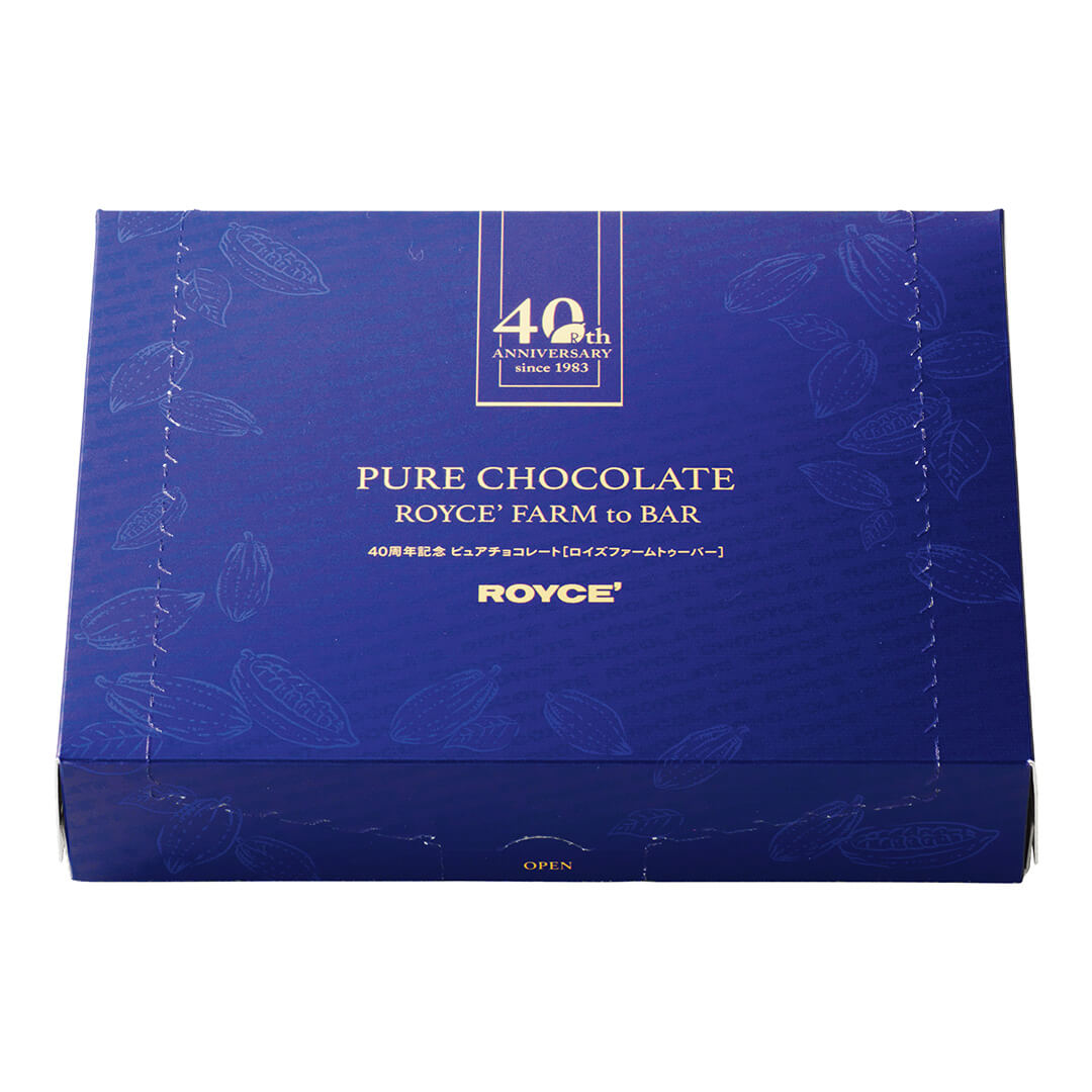 Image shows a printed blue box with gold text saying Text says 40th Anniversary since 1983. 40th Pure Chocolate ROYCE' Farm to Bar. ROYCE'.
