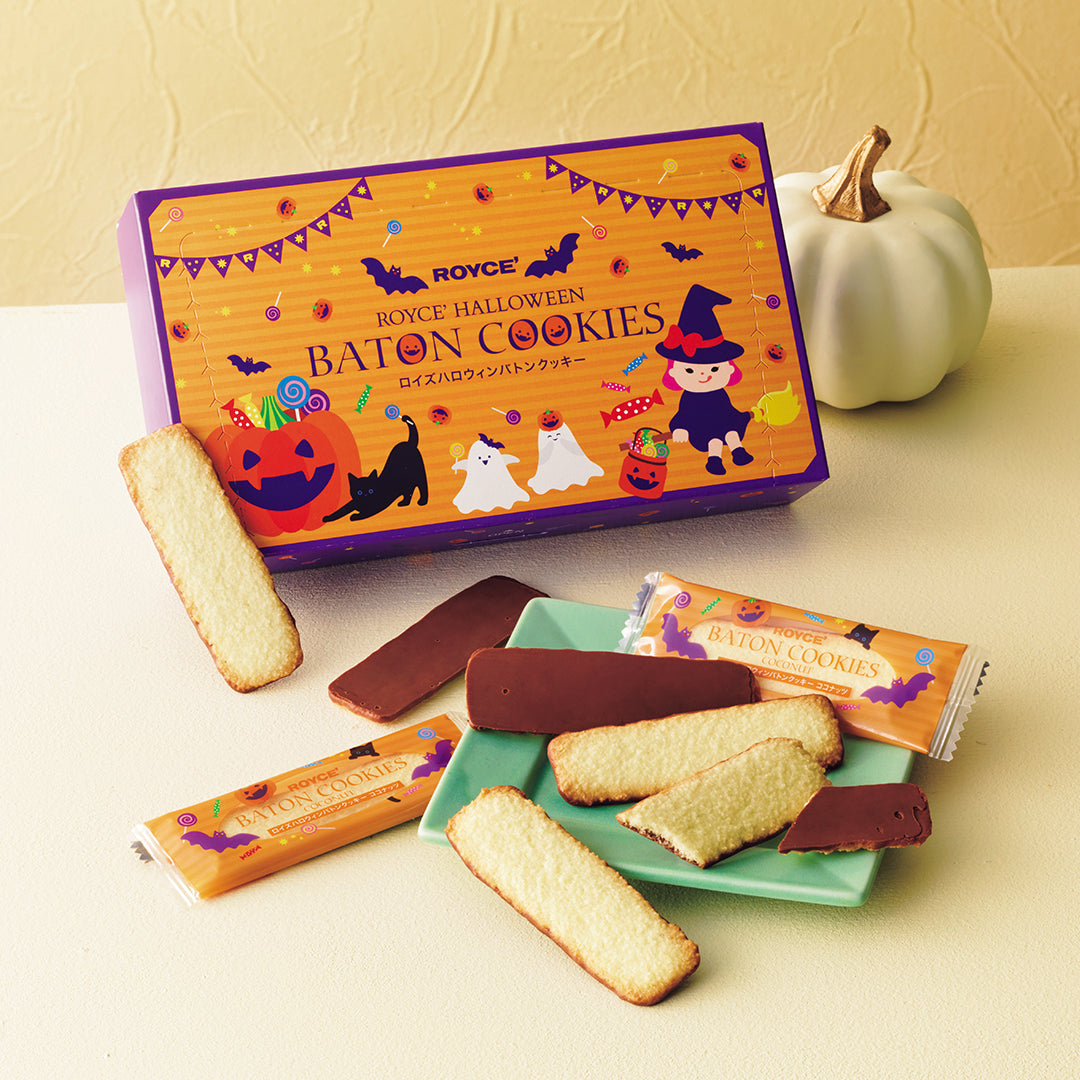 ROYCE' Halloween Baton Cookies - Images shows a purple and orange illustrated box, several wrapped cookies, and sliced cookies with chocolate coating on a mint green plate, set against a cream background with a small white pumpkin.