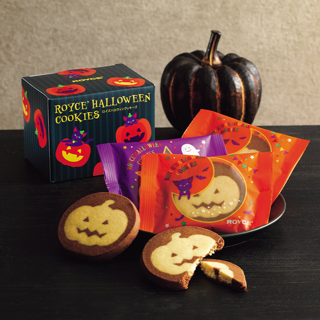 ROYCE' Halloween Cookies (5 Pcs) - Image shows a printed box in dark green and with illustrations of pumpkins. Accents include cookies, individually-wrapped confections with illustrations of cats and ghosts, and a black pumpkin.