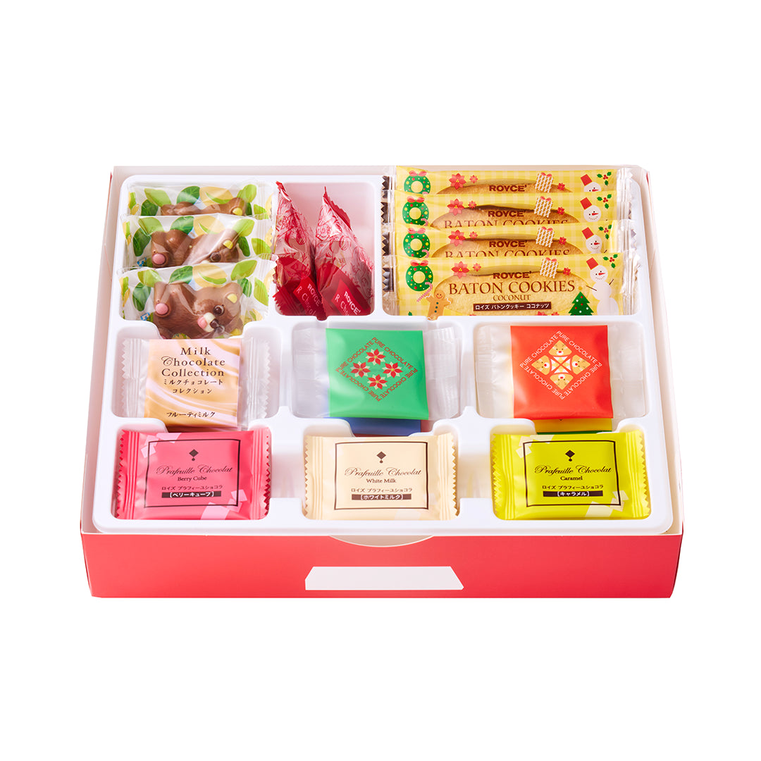 Assorted sweets in ROYCE' Happy Selection Box: Baton Cookies, Milk Chocolate Collection, Pure Chocolate, foil-wrapped chocolates, and cartoon-animal motif bags, holiday-themed gift.