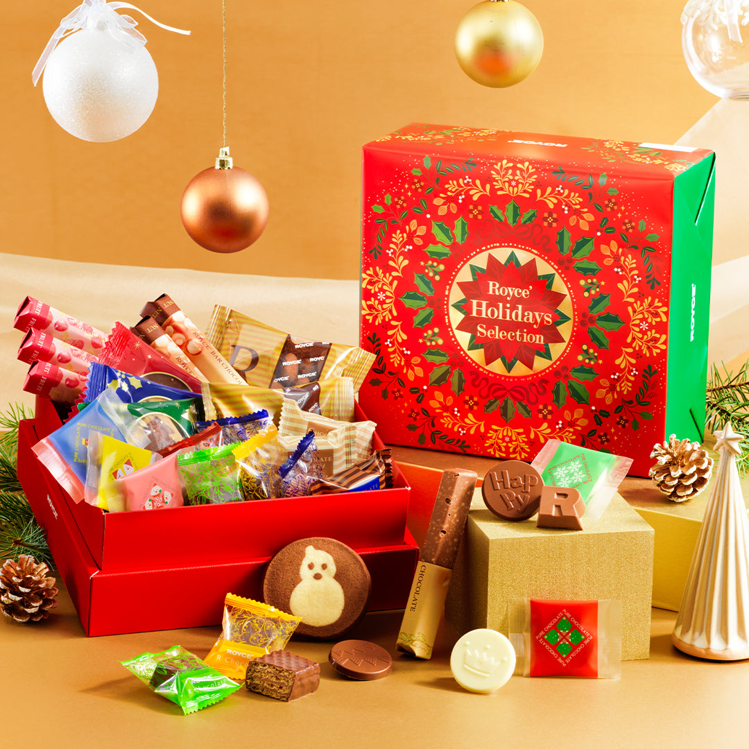 Image shows a festive gift box and an open box with individually-wrapped chocolates inside.