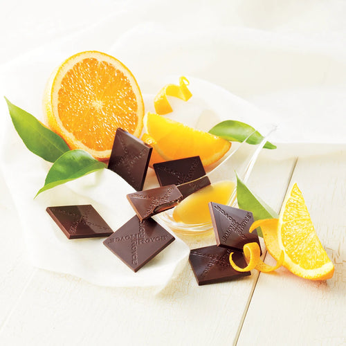 Prafeuille Chocolat Orange features milk chocolate squares with zesty orange sauce, shown with orange wedges, citrus leaves, and chocolate squares branded ROYCE.
