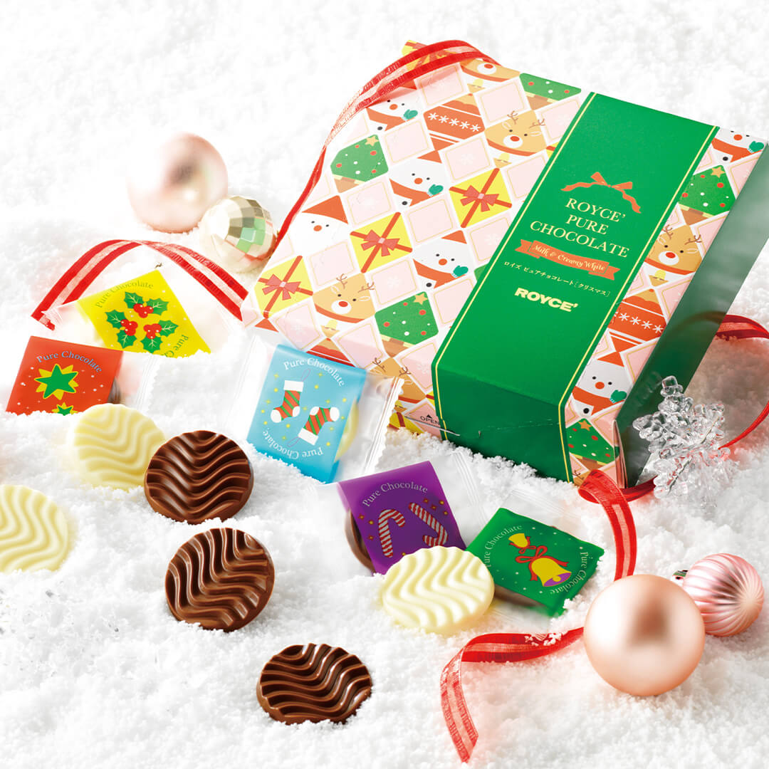 ROYCE' Chocolate - Pure Chocolate Christmas - ROYCE' Chocolate printed box with assorted chocolates on a snowy background. Accents include a red ribbon and decoration balls.