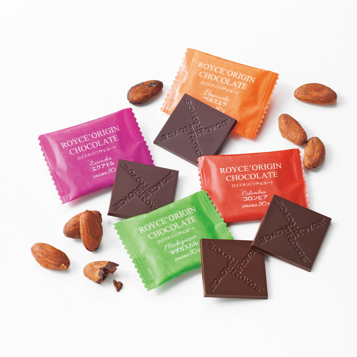 ROYCE' Chocolate - Image shows brown chocolate squares with the word ROYCE' etched on them and wrapped chocolates in red, orange, green, and pink with text saying ROYCE' Origin Chocolate. Accents include loose cacao beans.