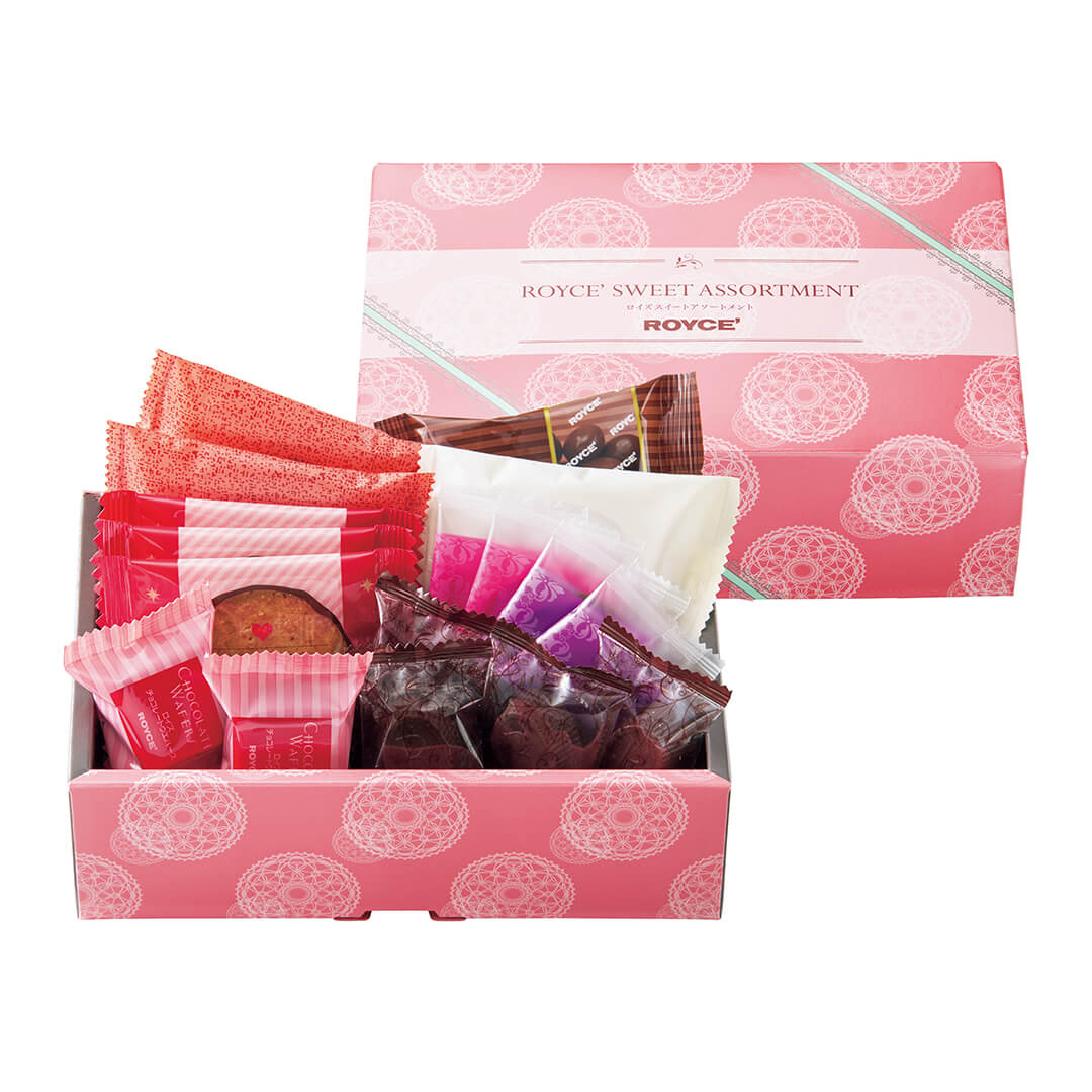 ROYCE' Chocolate - ROYCE' Sweet Assortment (17 Pcs) - Image shows two boxes with white background. Box on top right shows a pink box with lace-like prints in white and green. Text says ROYCE' Sweet Assortment ROYCE'. Box in bottom left shows an open pink box with individually-wrapped chocolates in various shapes, sizes, and colors.