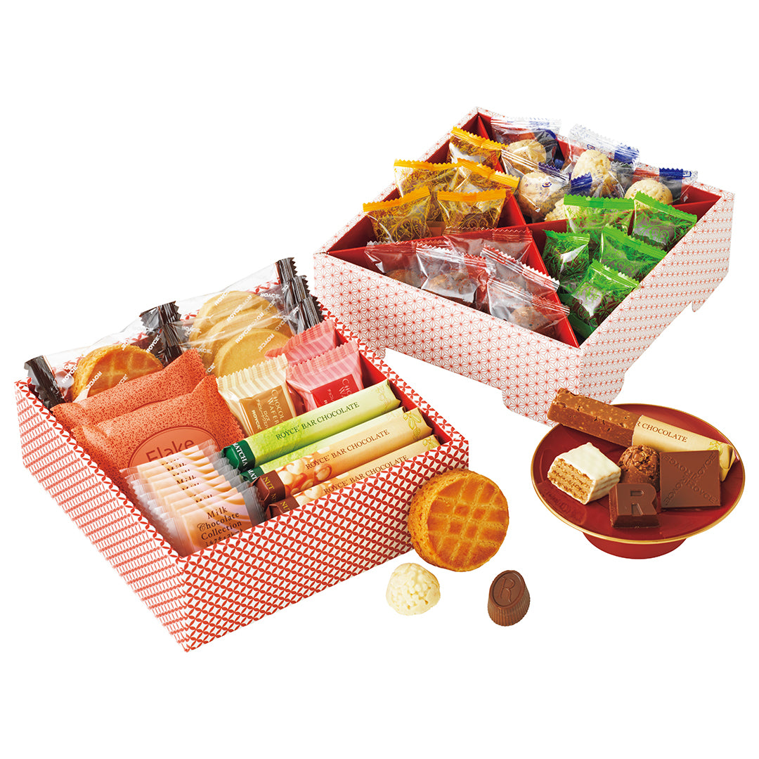 ROYCE' Sweets Osechi - Image shows open printed boxes with individually-wrapped confections inside. Accents include a small red plate with chocolates on it.