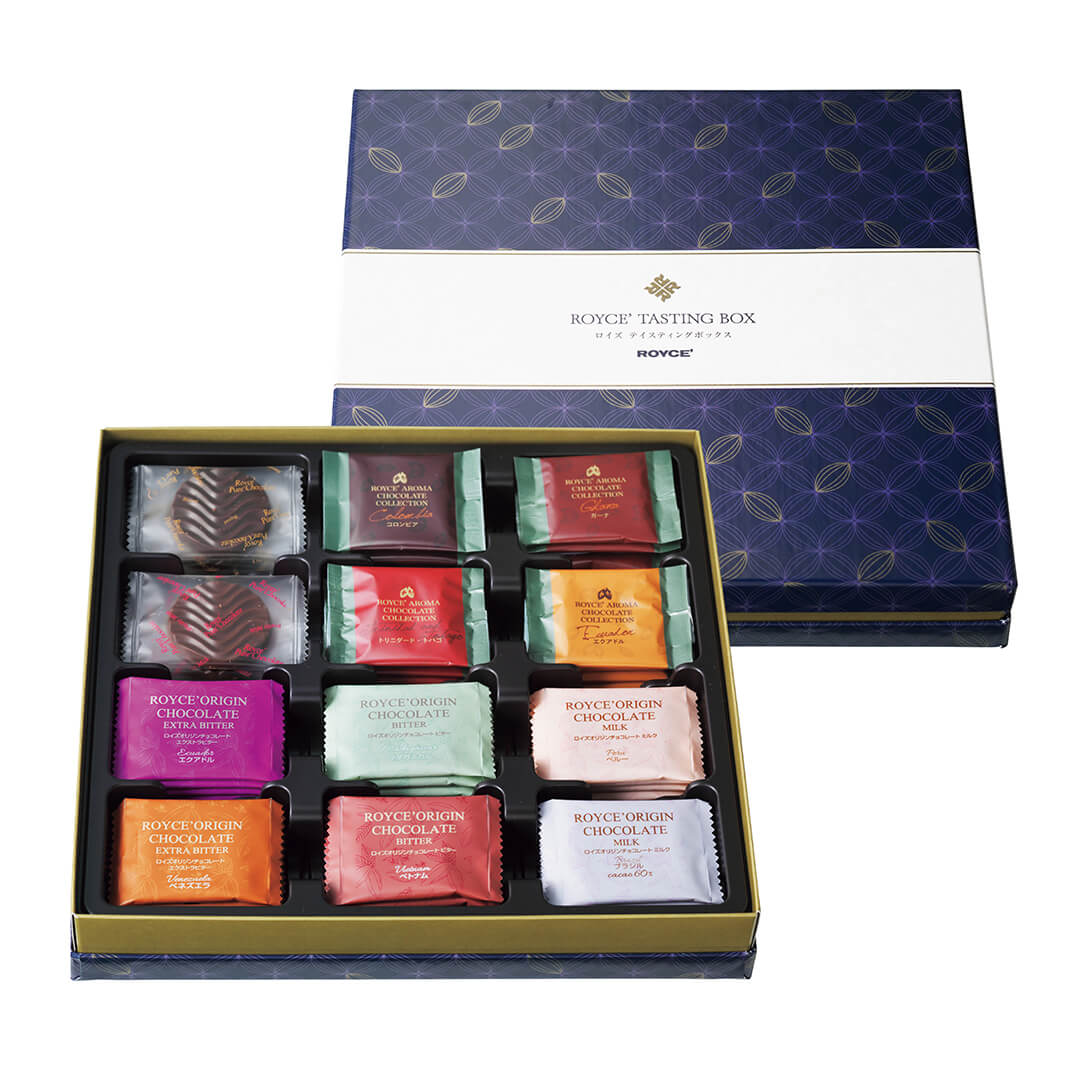 ROYCE' Chocolate - ROYCE' Tasting Box - Image shows (on top right) a blue box with cacao prints and a white center. Text in center says ROYCE' Tasting Box ROYCE' and (on lower left) an open box with individually-wrapped confections in different colors.