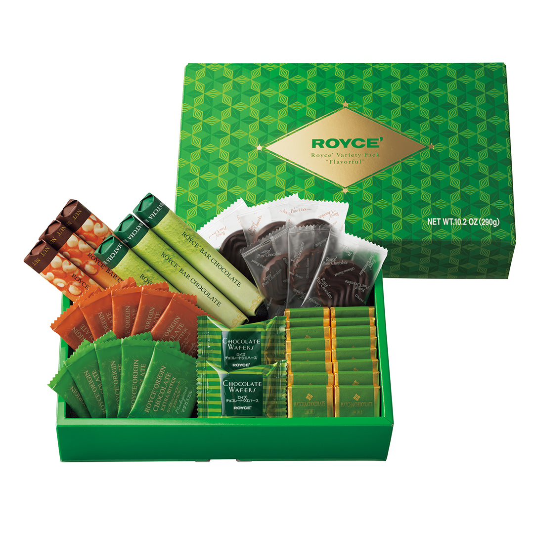 ROYCE' Variety Pack "Flavorful" - A ROYCE' gift set in a green box, shown open with assorted chocolate bars and wrapped chocolate pieces inside. The green box lid is positioned behind the open tray, and the packaging displays the ROYCE brand name on a gold label.