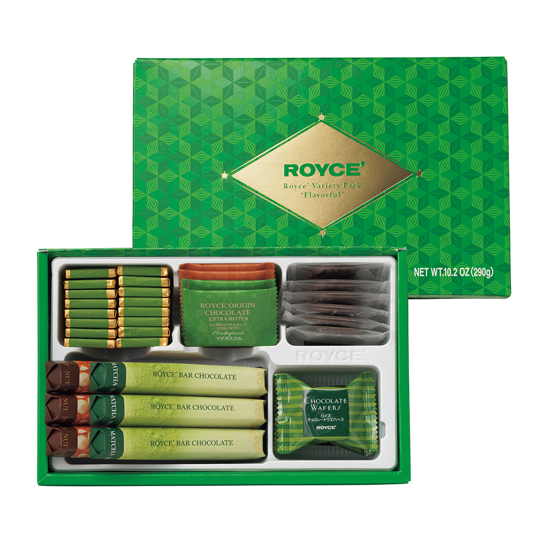 ROYCE' Variety Pack "Flavorful" - A ROYCE' gift set in a green box, shown open with assorted chocolate bars and wrapped chocolate pieces inside. The green box lid is positioned behind the open tray, and the packaging displays the ROYCE brand name on a gold label.