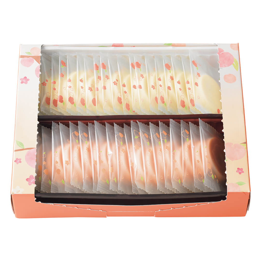 ROYCE' Chocolate - Hakutouberry & Hakutouwhite Chocolate - Image shows an open box in the colors of peach and orange with illustrations of peaches, flowers, twigs, and leaves on each side. Inside of the box shows individually-wrapped chocolate discs in white (inset above) and light pink (inset below). Chocolates' wrappers are transparent with prints of peaches and flowers in pink and green.