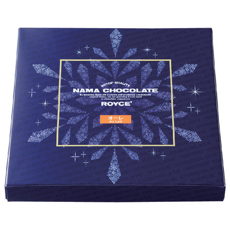 Image shows a blue box printed with the words ROYCE' Chocolate and has illustrations of a snowflake and stars in white and golden square in the middle. Text says ROYCE' Quality Nama Chocolate By breaking down old customs and producing consistently original items, we are pursuing a new level in chocolate enjoyment. ROYCE' Au Lait.