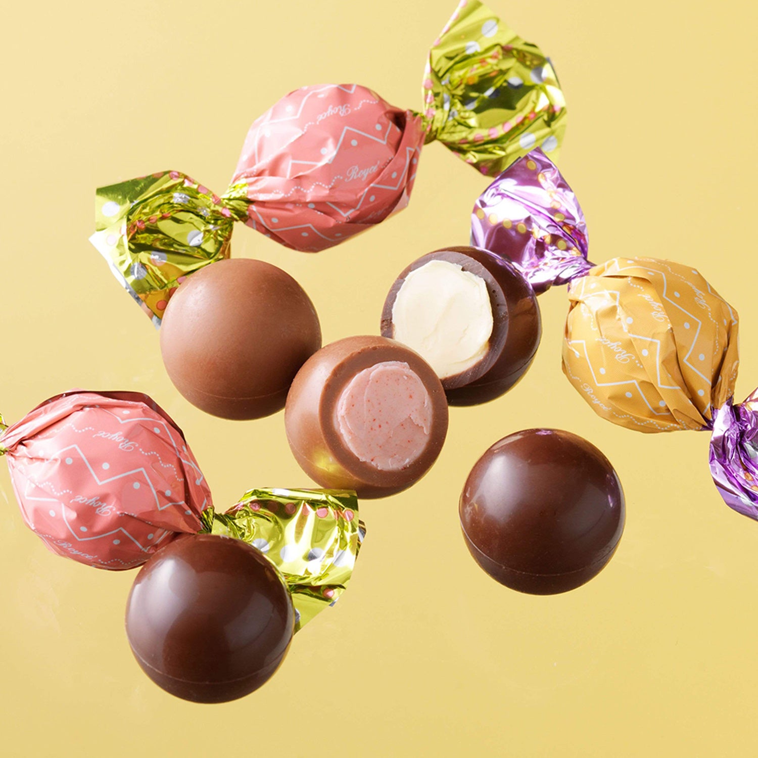 ROYCE' Chocolate - ROYCE' Petit Ball Chocolat "Strawberry & Lemon" - Image shows a variety of round-shaped chocolates in different colors both wrapped and unwrapped with a yellow background. 