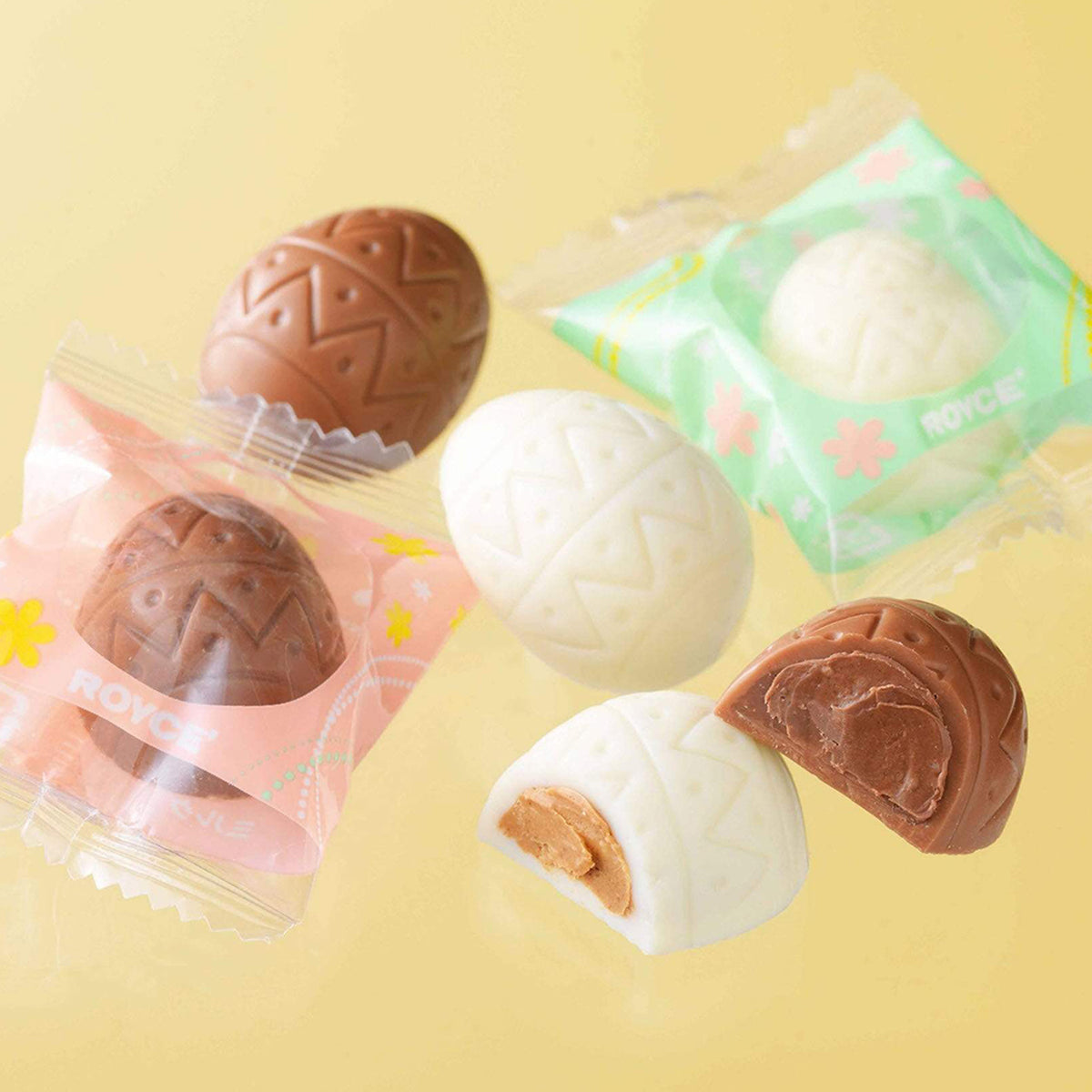 ROYCE' Chocolate - ROYCE' Chocolate Box "Sweet Eggs" - Image shows brown and white chocolate eggs with green and red wrapping.  Background is in yellow.