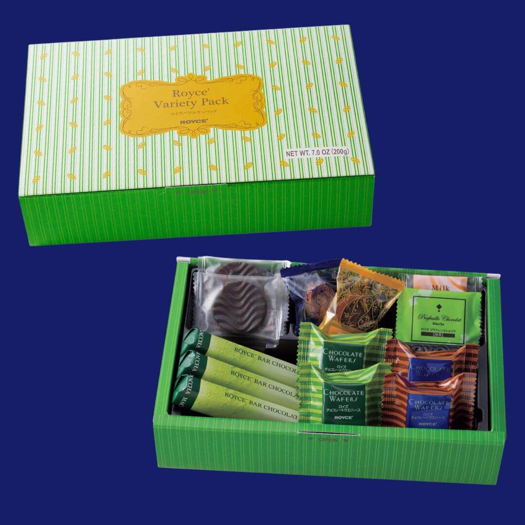 ROYCE' Chocolate - ROYCE' Variety Pack "Flavorful" - Image shows two green boxes with a blue background. Box on upper left shows a green box with leaf prints. Text on top says ROYCE' Variety Pack ROYCE' Net Wt 7.0 Oz (200g). Text below says Open. Box on lower right shows an open box with various chocolates in different shapes, sizes, and colors. Visible texts from left are Matcha ROYCE' Bar Chocolate, Chocolate Wafers, ROYCE', Milk, Prafeuille Chocolat Matcha.