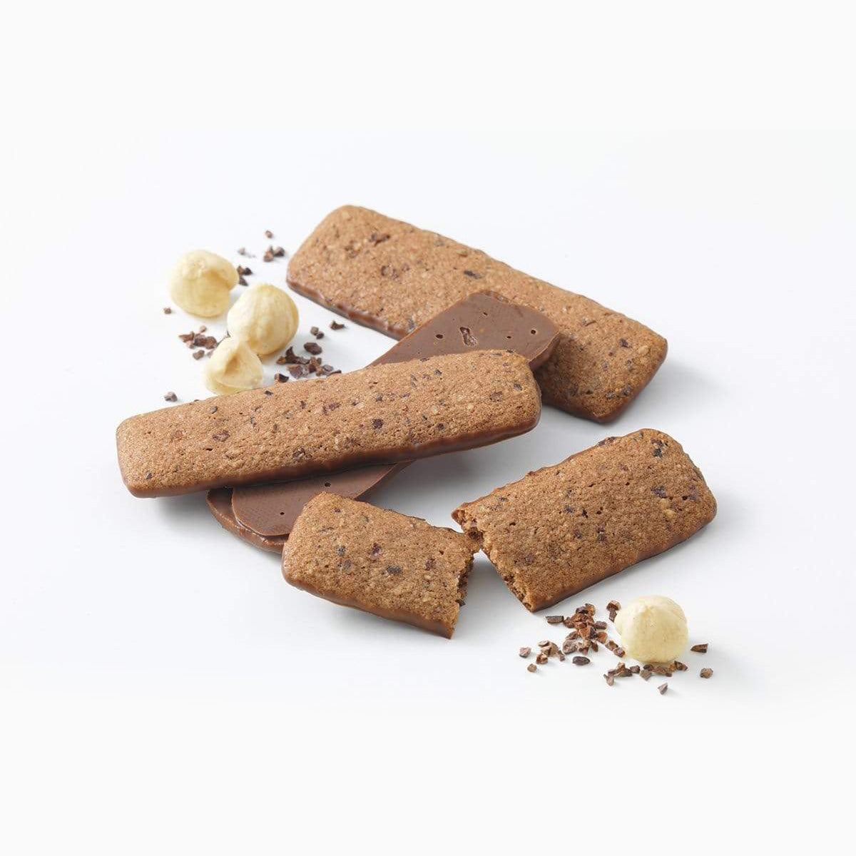 ROYCE' Chocolate - Baton Cookies "Hazel Cacao" - Image shows brown cookies with brown chocolate chips coated with brown chocolate. Accents include nuts in various shapes and chocolate shavings.