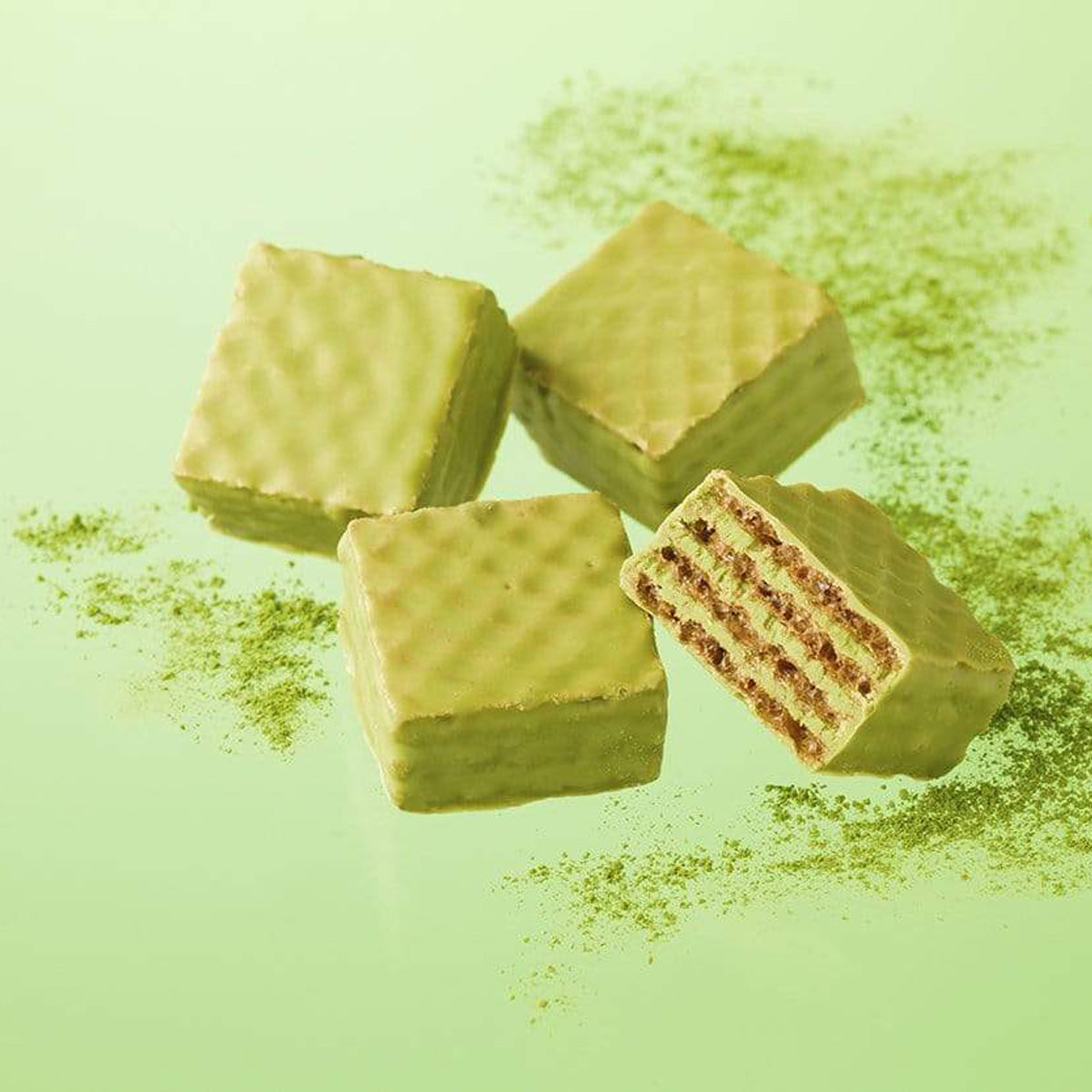 ROYCE' Chocolate - Chocolate Wafers "Matcha" - Image shows green chocolate wafers with a crisscross texture. Background is in green and has sprinkles of green tea powder.