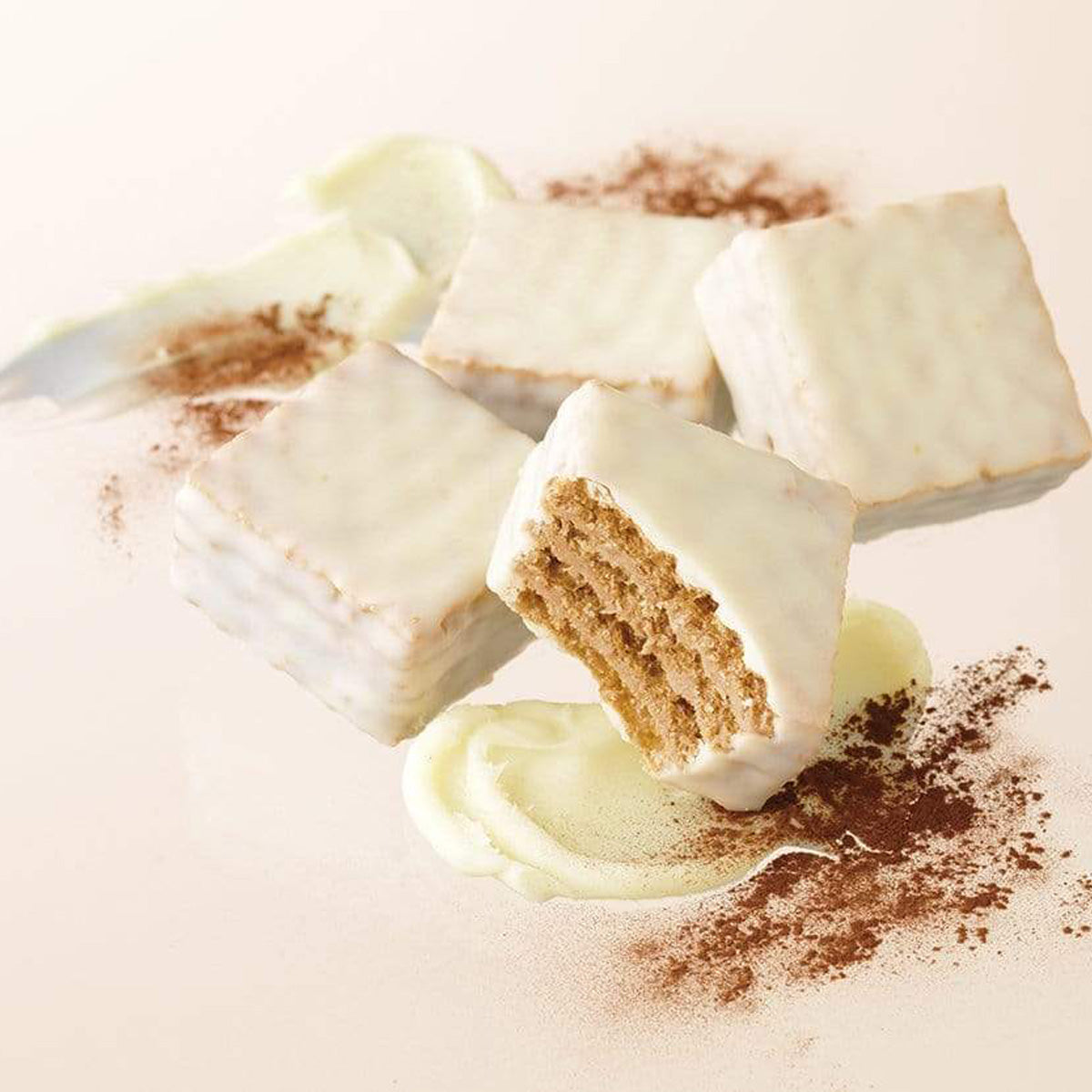 ROYCE' Chocolate - Chocolate Wafers "Tiramisu Cream" - Image shows white chocolate wafers. Background is in light brown with accents of white whipped cream and brown chocolate powder.