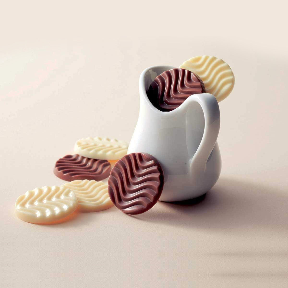 ROYCE' Chocolate - Pure Chocolate "Caramel Milk & Creamy White" - Image shows brown and white chocolate discs, some placed in a white porcelain mug. Background is in light brown.